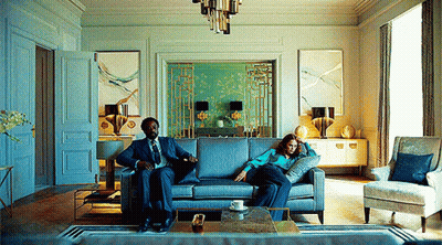 Man And Woman Sitting On Couch GIF