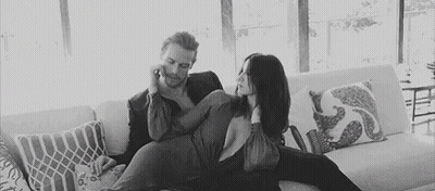 Man And Woman Sitting On Couch GIF