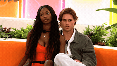 Man And Woman Sitting On Couch GIF