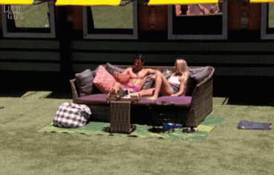 Man And Woman Sitting On Couch In Front Of Building Saying Liu GIF