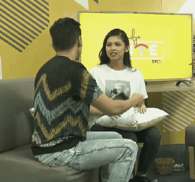 Man And Woman Sitting On Couch In Front Of TFC TV GIF