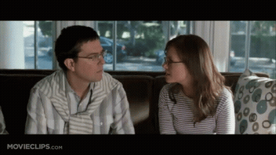 Man And Woman Sitting On Couch Looking At Each Other GIF