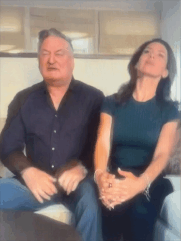 Man And Woman Sitting On Couch Looking Up GIF