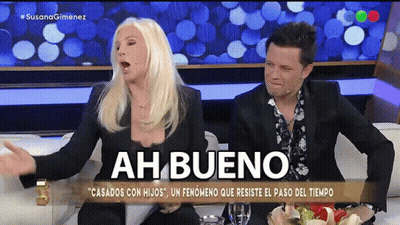 Man and Woman Sitting on Couch Saying Ah Bueno