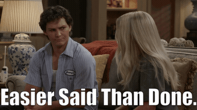 Man And Woman Sitting On Couch Saying Easier Said Than Done GIF