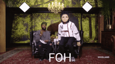 Man And Woman Sitting On Couch Saying Foh GIF