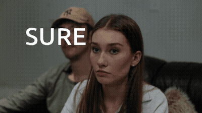 Man And Woman Sitting On Couch Saying Sure GIF
