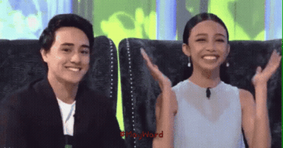 Man And Woman Sitting On Couch With Hands In Air GIF