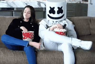Man And Woman Sitting On Couch With Marshmallows On Heads GIF