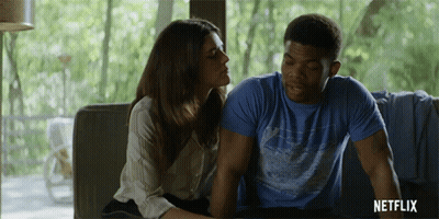 Man and Woman Sitting on Couch With Netflix