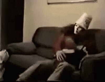 Man And Woman Sitting On Couch With Pillow On Head GIF