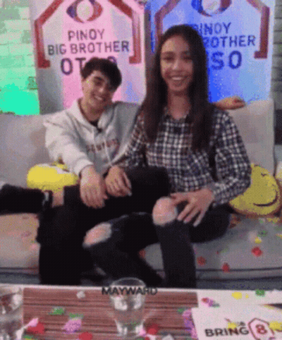 Man And Woman Sitting On Couch With Pinoy Big Brother Sign GIF