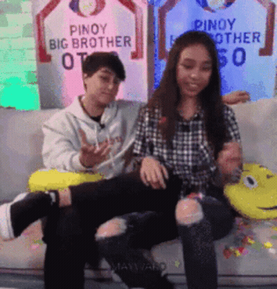 Man And Woman Sitting On Couch With Pinoy Big Brother Sign GIF