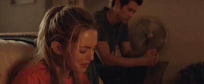 Man And Woman Sitting On Couch Woman Covering Mouth GIF