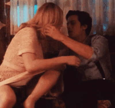 Man And Woman Sitting On Couch Woman Taking Off Shirt GIF