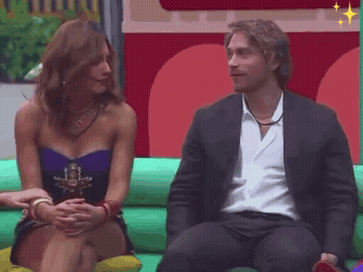 Man And Woman Sitting On Green Couch GIF