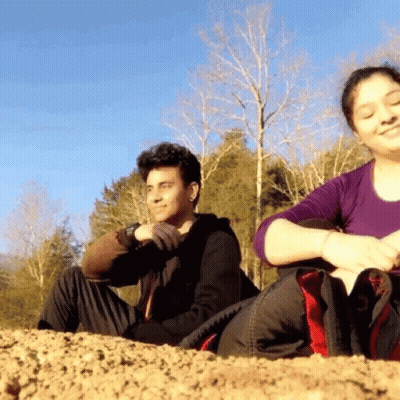 Man And Woman Sitting On Hill GIF