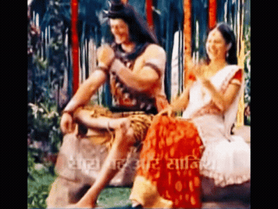 Man And Woman Sitting On Rock GIF