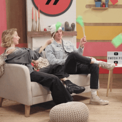 Man And Woman Sitting On Smosh Sign GIF
