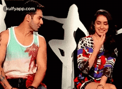 Man And Woman Sitting On Stage GIF