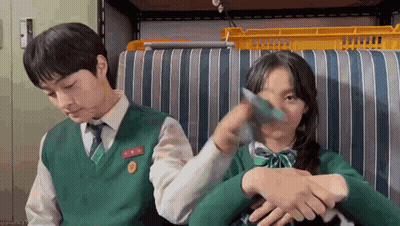 Man And Woman Sitting On Striped Couch GIF