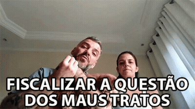 Man And Woman Sitting With Dog Fiscalizar A Questão Dos Maus Tratos GIF