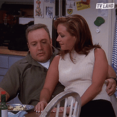 Man And Woman Sitting With TV Land Logo On Fridge GIF