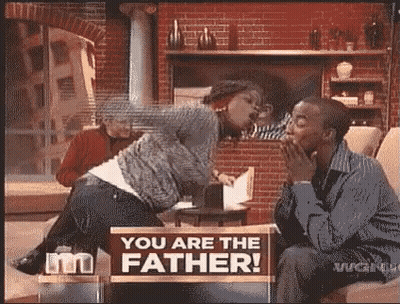 Man And Woman Sitting With You Are The Father Sign GIF