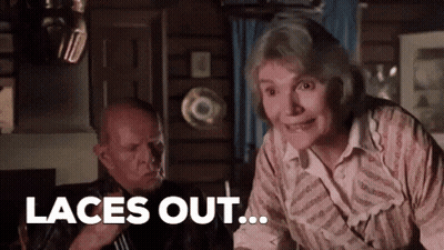 Man And Woman Sitting Woman Smiling Says Laces Out GIF