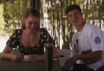 Man And Woman Smiling At Table GIF