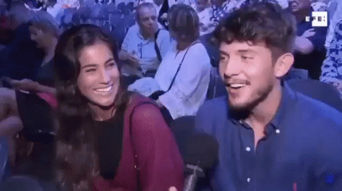 Man And Woman Smiling In Crowd GIF