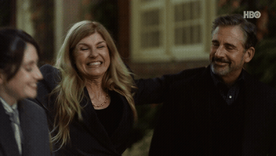 Man And Woman Smiling In Front Of HBO Building GIF