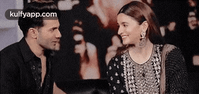 Man And Woman Smiling Sitting Together GIF