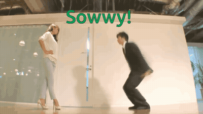 Man And Woman Squatting In Front Of Sowwy Wall GIF