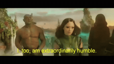 Man And Woman Standing As Woman Says I Too Am Extraordinarily Humble GIF