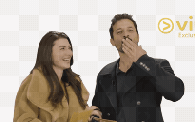 Man And Woman Standing At Ovi Exclus Sign GIF
