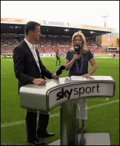 Man And Woman Standing At Skysport Podium GIF