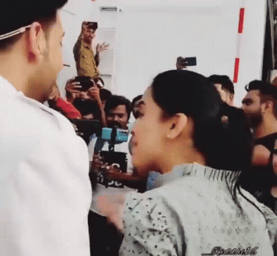 Man And Woman Standing Before Crowd GIF