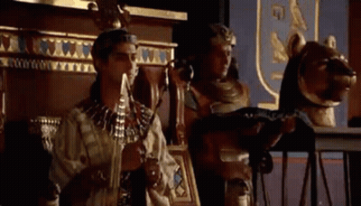 Man And Woman Standing Beside Statue GIF