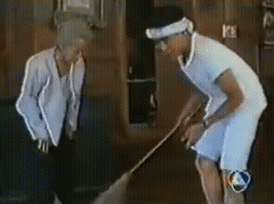Man And Woman Standing Beside Sweeping Man GIF