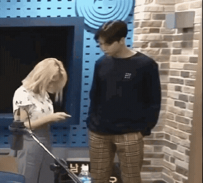Man And Woman Standing By Brick Wall GIF