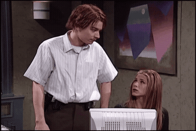 Man And Woman Standing By Computer Monitor GIF