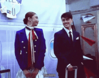 Man And Woman Standing By Heyward Sign GIF