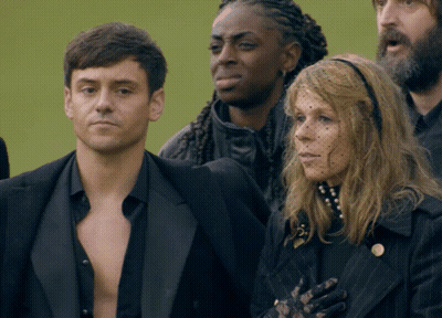 Man And Woman Standing In Crowd GIF