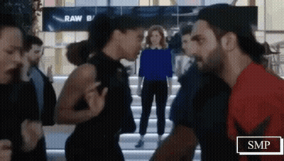 Man And Woman Standing In Crowded Area GIF