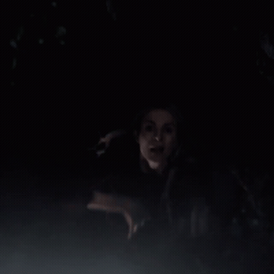 Man And Woman Standing In Dark Looking At Something GIF