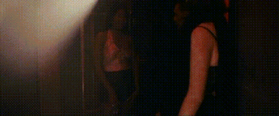 Man And Woman Standing In Dark Room GIF
