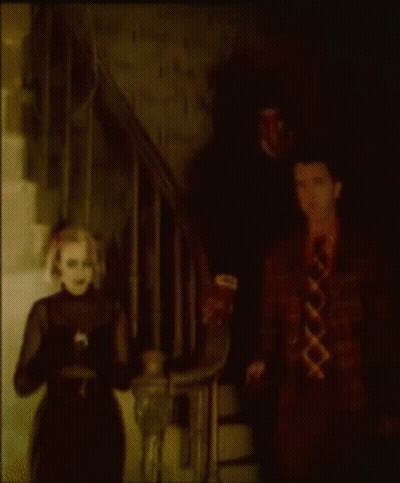 Man And Woman Standing In Dark Room GIF