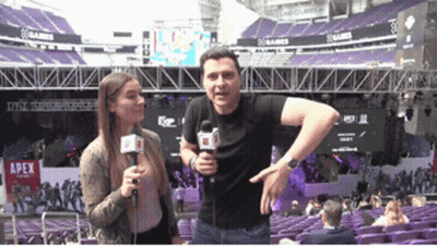 Man And Woman Standing In Front Of Apex Stadium GIF