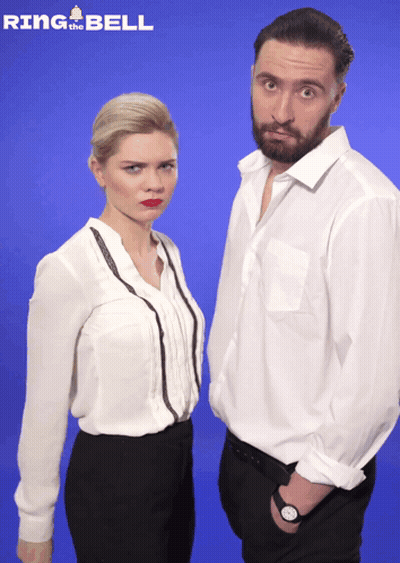 Man And Woman Standing In Front Of Blue Background Saying Ring The Bell GIF